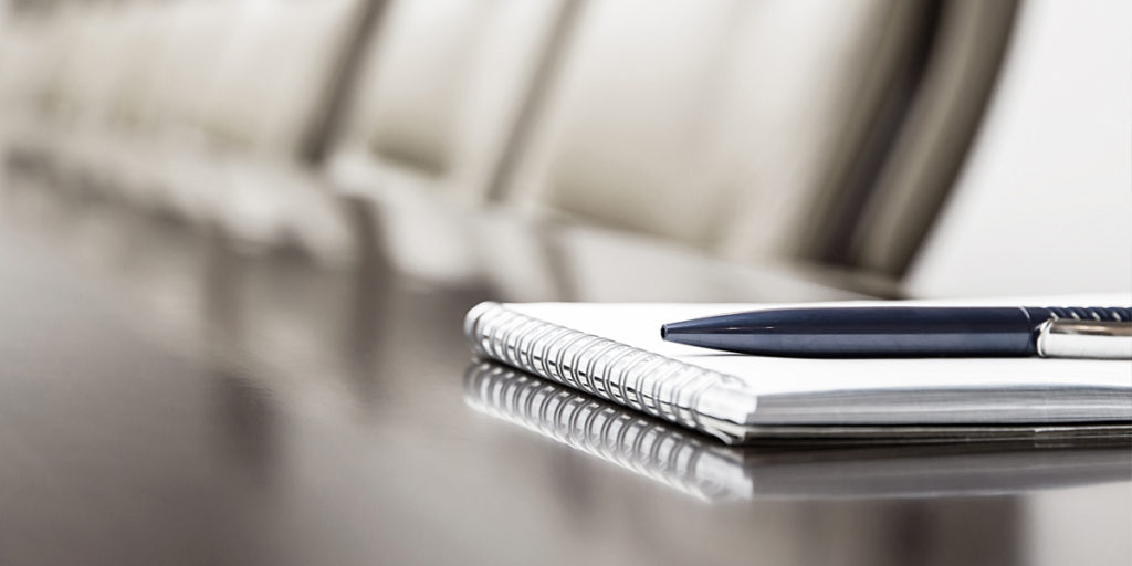 Pen and notebook on table